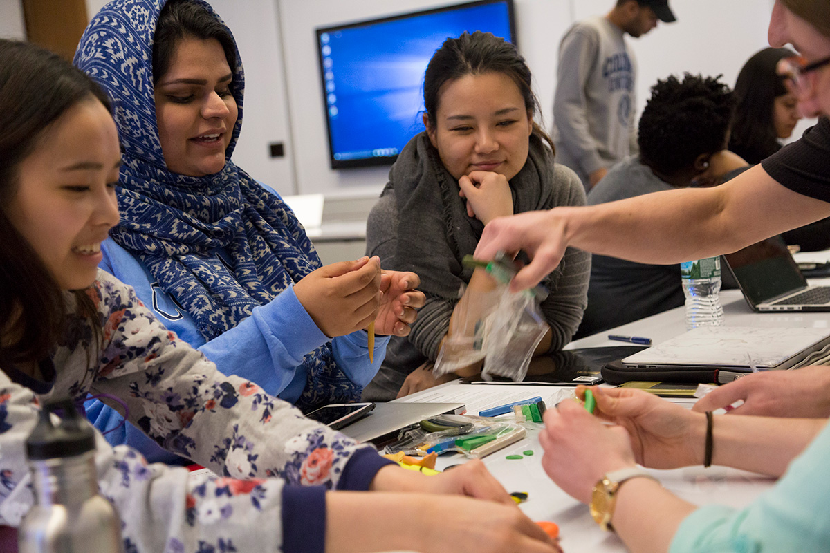 International students collaborating around a classroom table